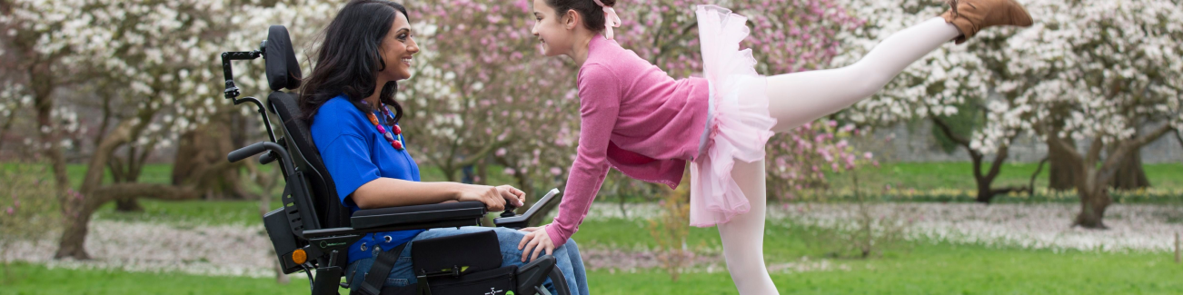 Woman in wheelchair with child ballerina